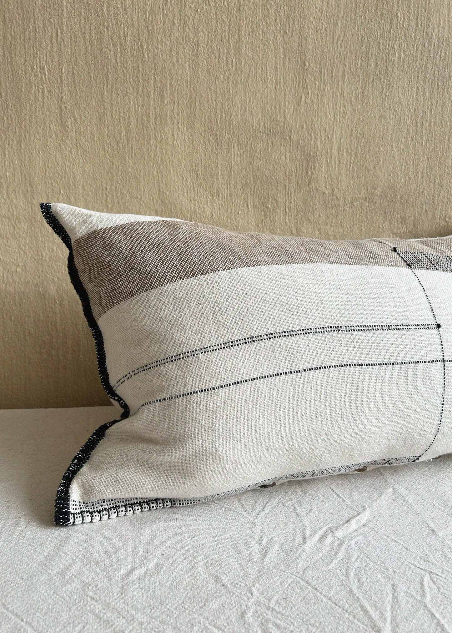 Handwoven, hand stitched local, natural cotton cushion featuring black borders and zen like lines